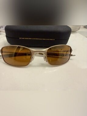 Oakley Silver Titanium-Style Sunglasses with Brown Lenses